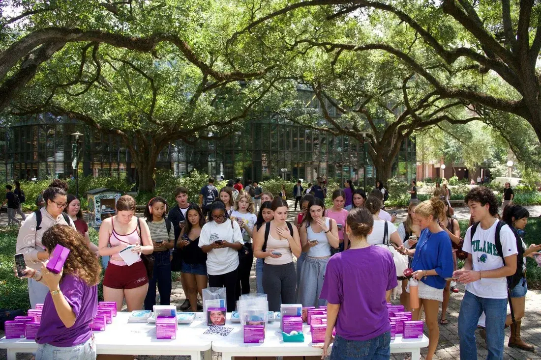 Students receiving skincare samples at a Fizz campus activation at Tulane
